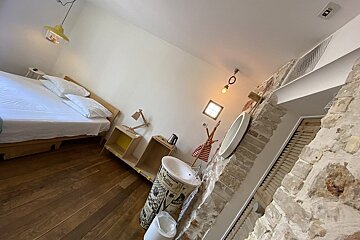 A bathroom with a sink and a newspaper on the wall