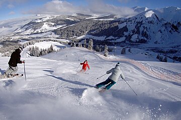 two skiers following an instructor