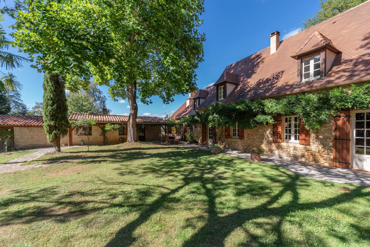 A large house with a lot of windows and shutters