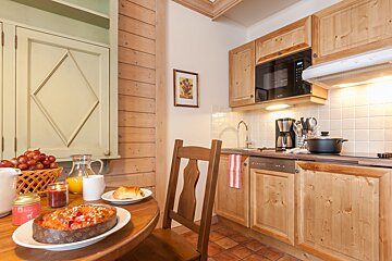A kitchen with wooden cabinets and a microwave that says ' siemens ' on it