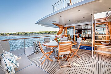 A table and chairs on the deck of a stella yacht