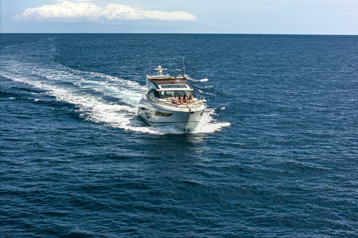 A boat with people on it is floating in the ocean