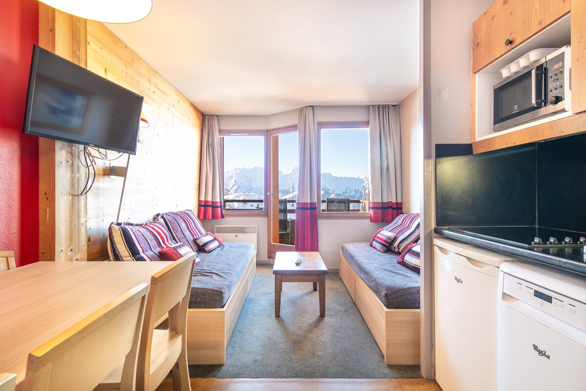 A living room with two couches and a flat screen tv