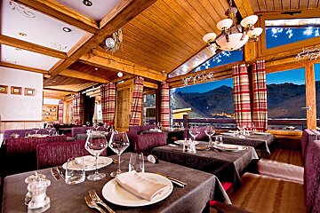 A dining room with a view of the mountains