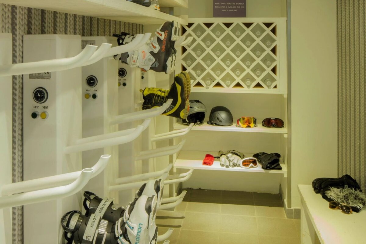 A salomon ski boot is hanging on a rack