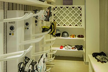 A salomon ski boot is hanging on a rack