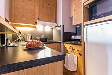 A kitchen with a microwave that says ' whirlpool ' on it