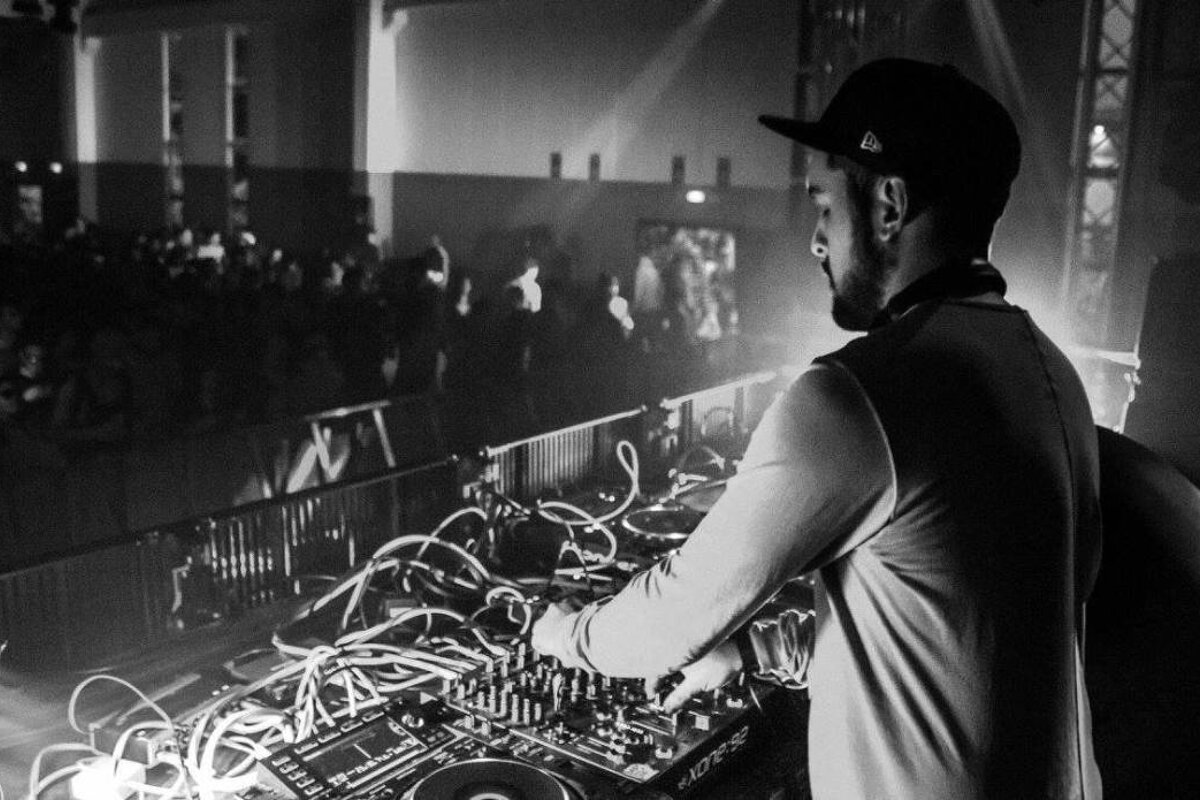 a DJ playing in a warehouse