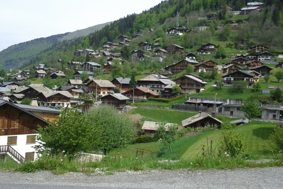 A small village sits on the side of a mountain