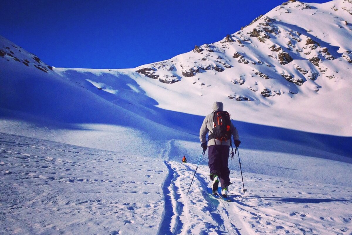 A person skiing down a snow covered mountain