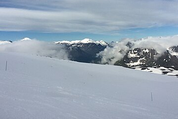 blue piste marker poles on the glacier in val disere