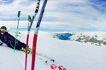 a female skier lying on her side on the snow