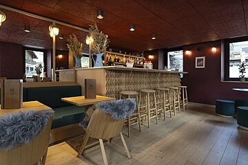 A glass of water with ice and a straw on a napkin