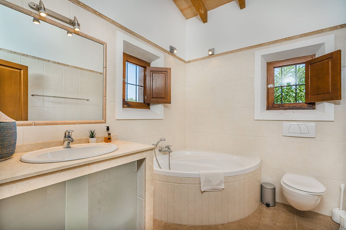 A bathroom with a tub a sink and a toilet