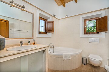 A bathroom with a tub a sink and a toilet