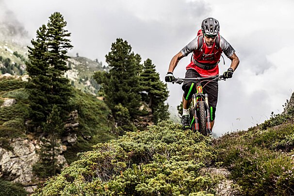 A man wearing a red shirt that says scott on it