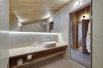 A bathroom with a sink and a large mirror