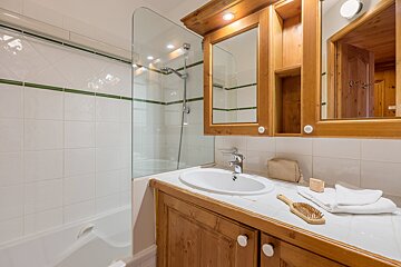 A bathroom with a sink and a brush on the counter