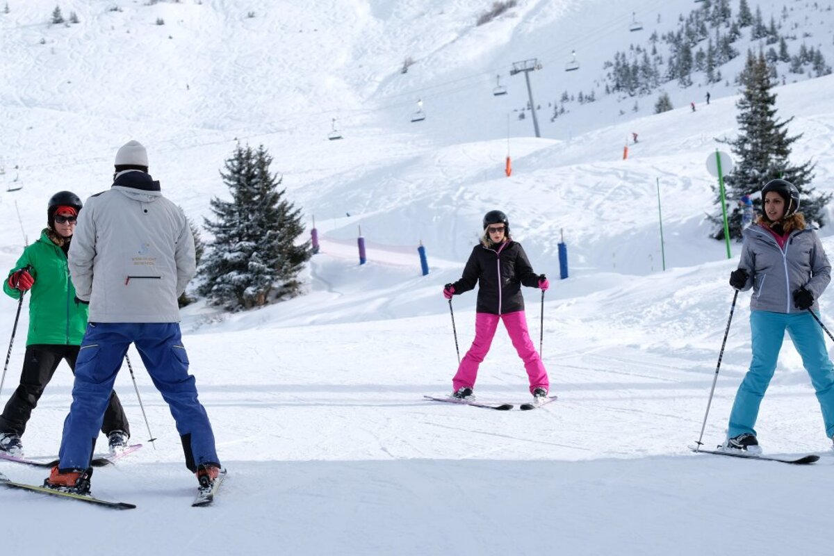 a ski instructor giving a group lesson