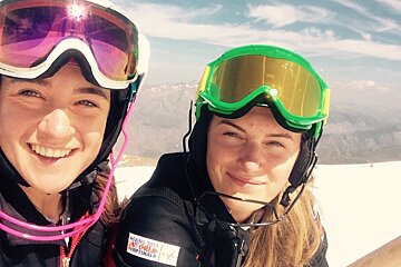 two ski racers smiling at the camera