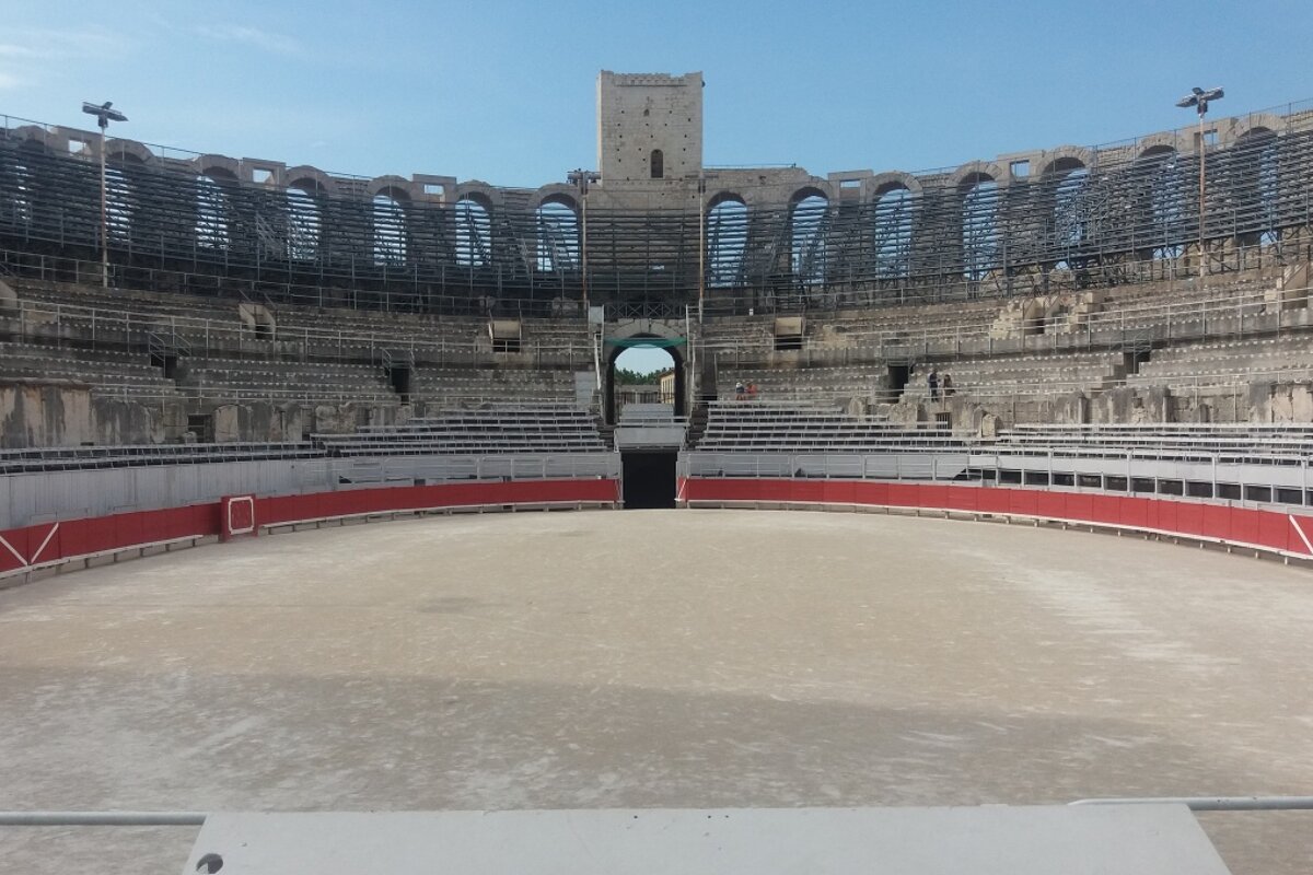 An empty stadium with a tower in the background
