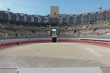 An empty stadium with a tower in the background