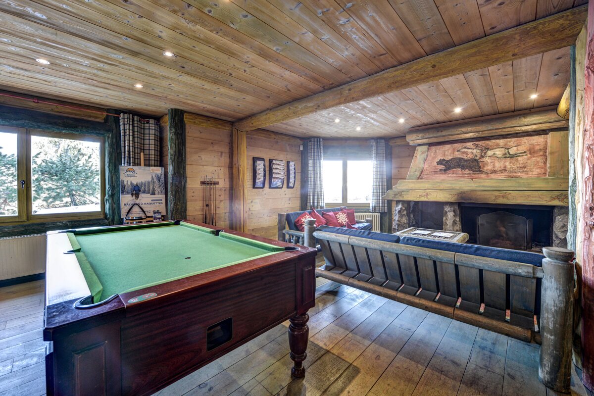 A pool table in the middle of a living room