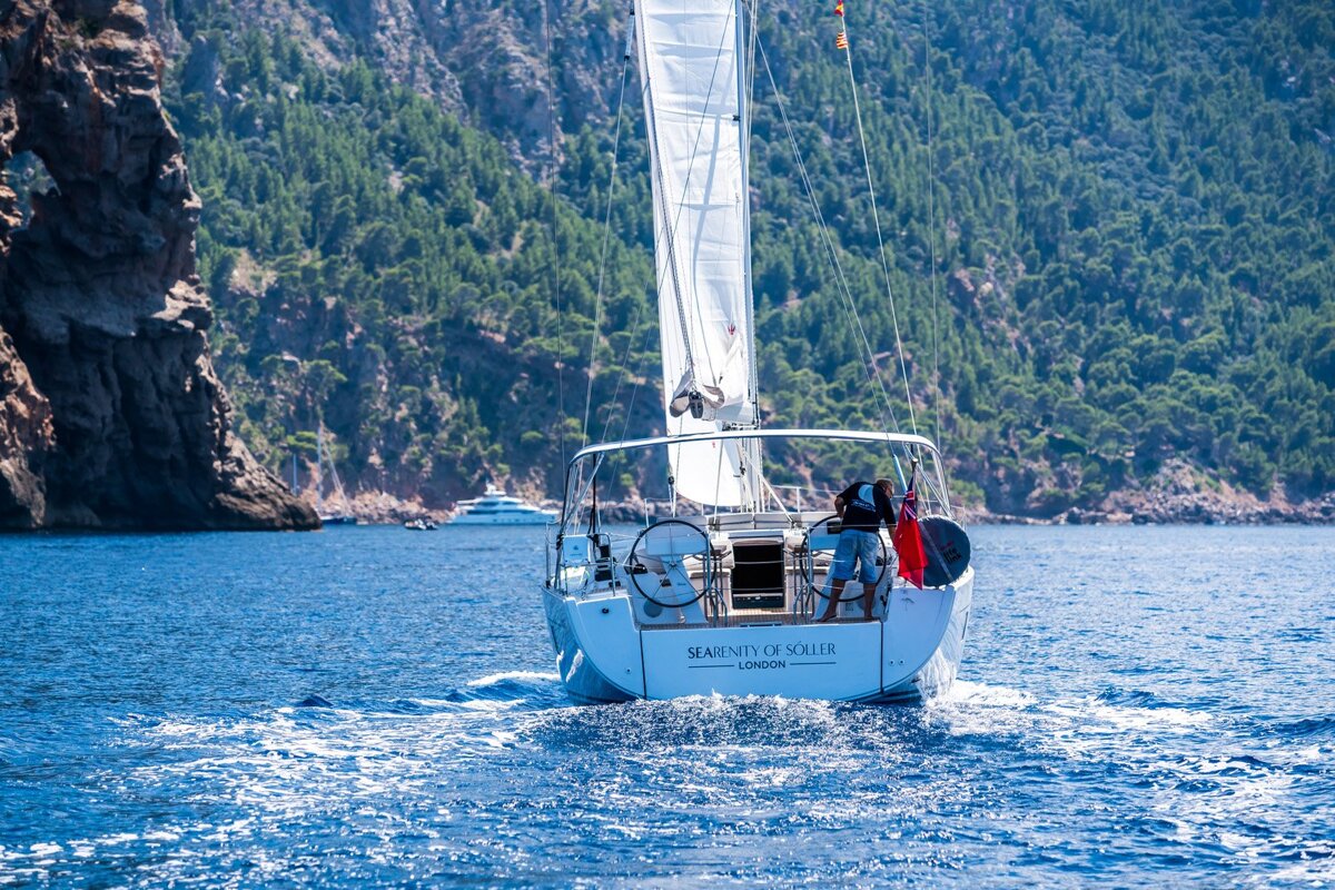 A sailboat with the name serenity of soler on the side