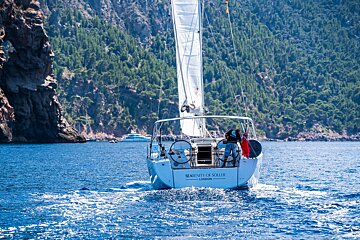 A sailboat with the name serenity of soler on the side