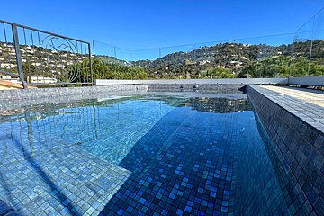 A swimming pool with a view of mountains and trees