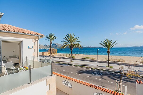 A balcony with a view of the beach and ocean