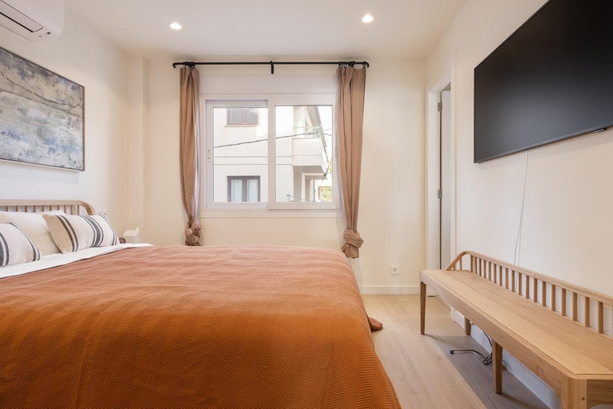 A bedroom with a large bed and a flat screen tv