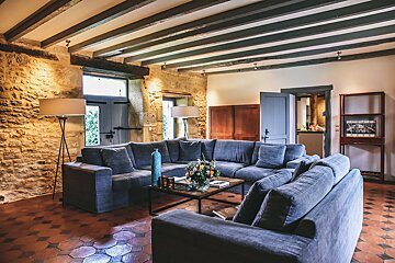 A living room with a large sectional couch and a coffee table