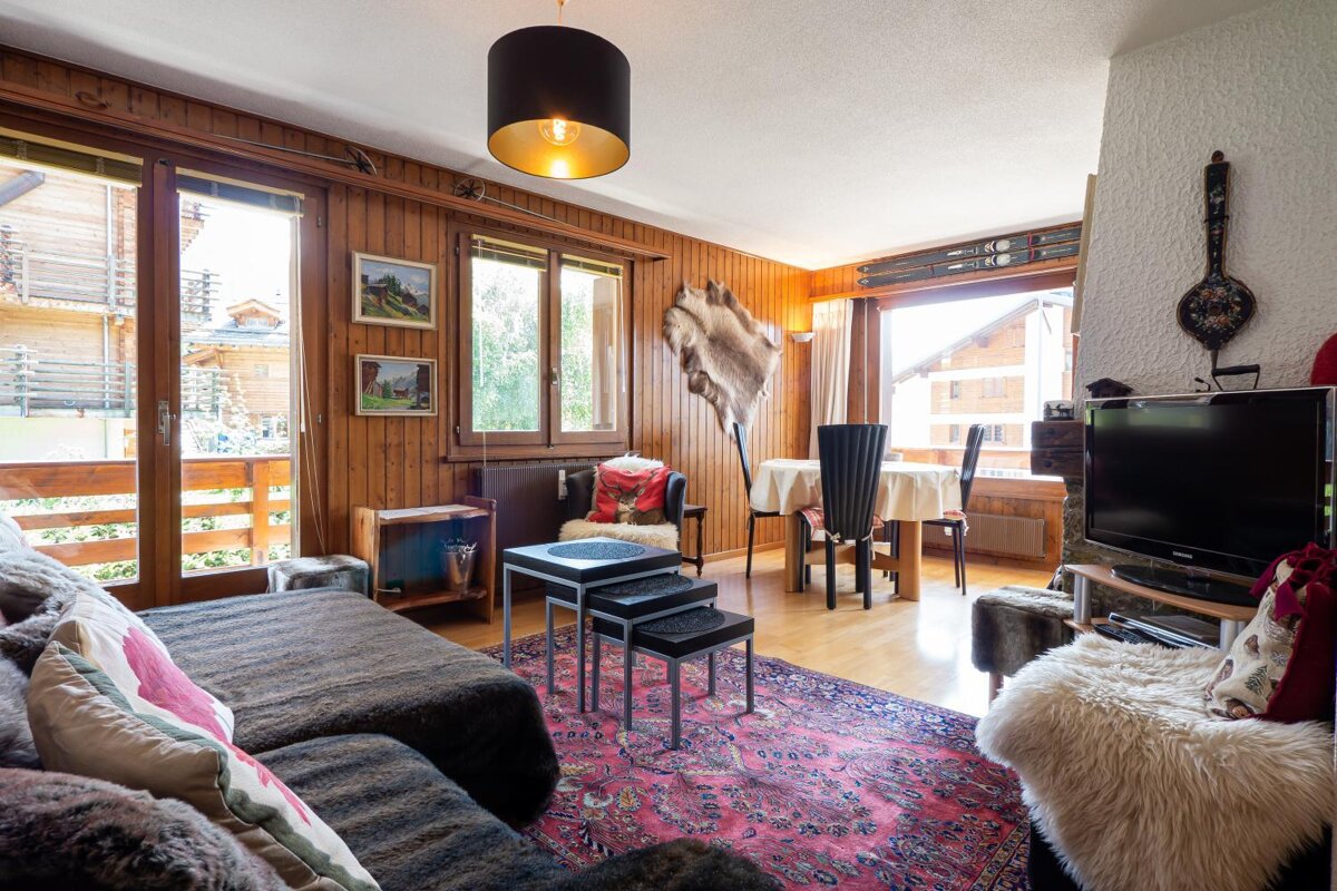 A living room with a couch and a flat screen tv