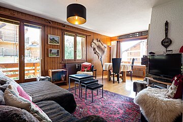A living room with a couch and a flat screen tv