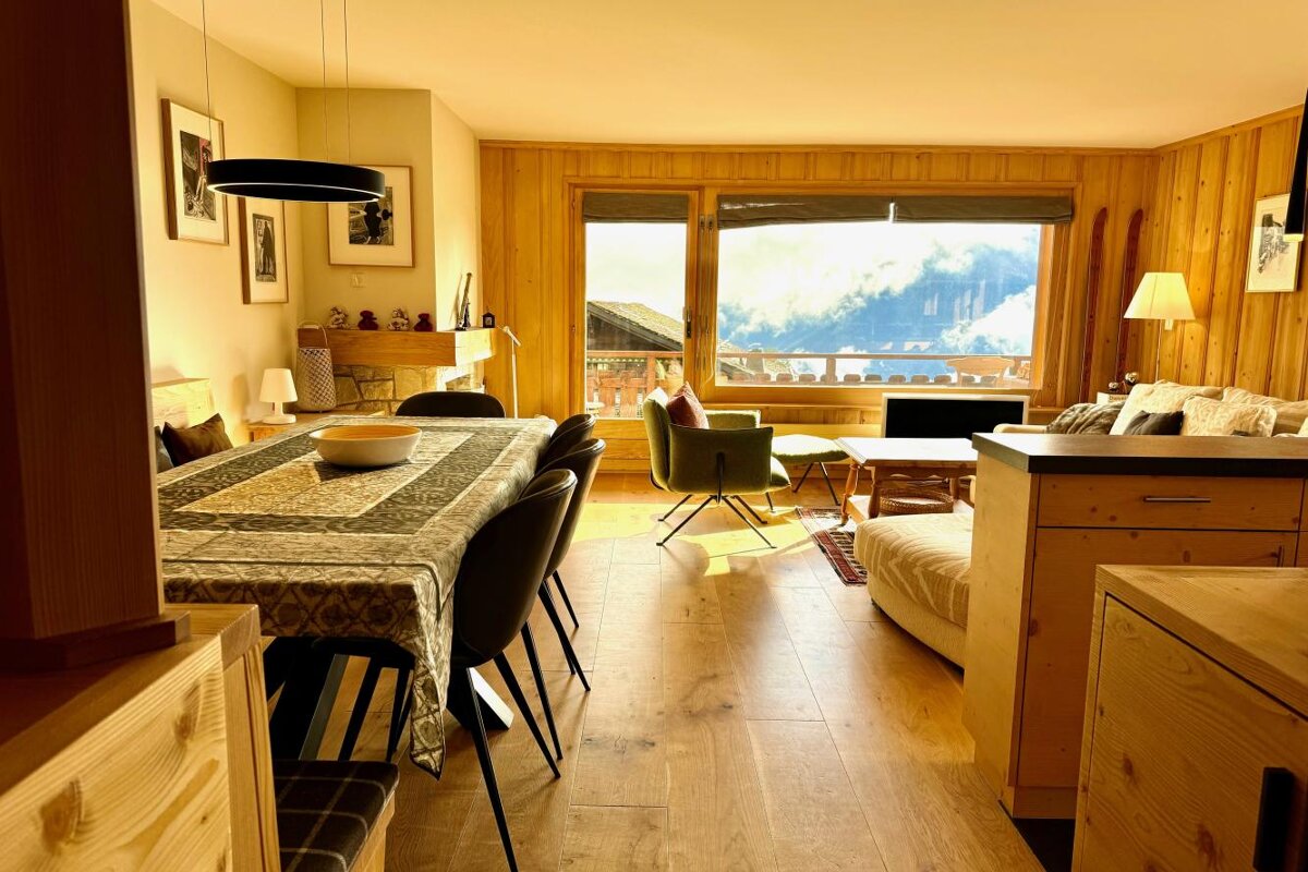 A living room with a dining table and chairs