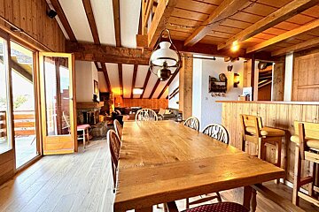 A wooden table and chairs in a living room