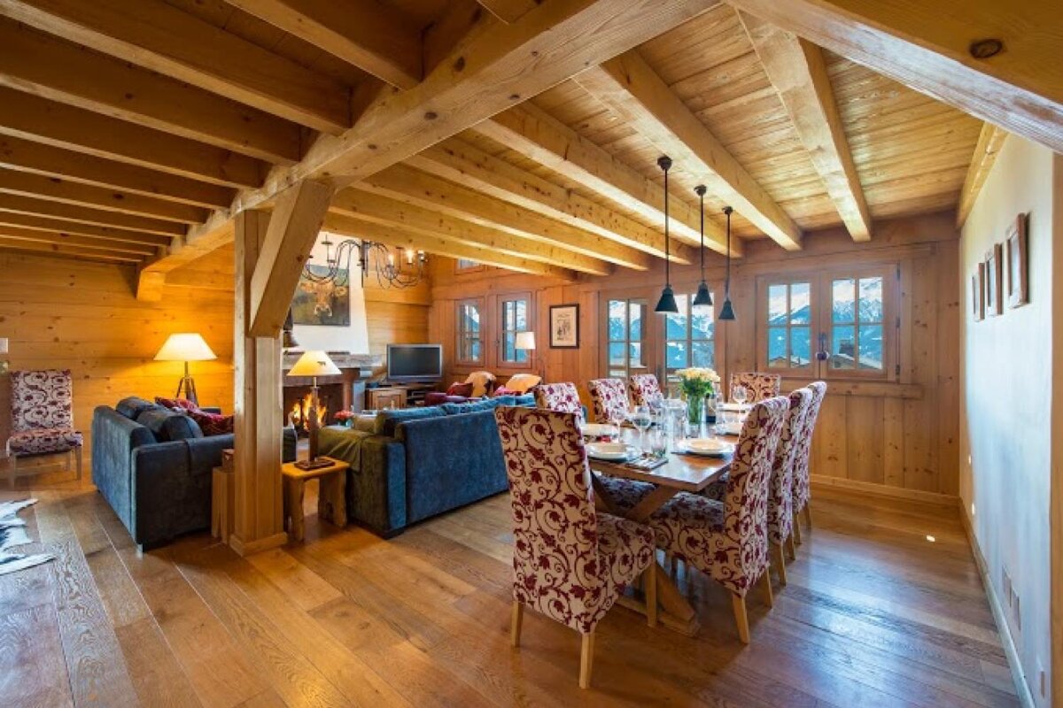 A living room and dining room in a wooden cabin
