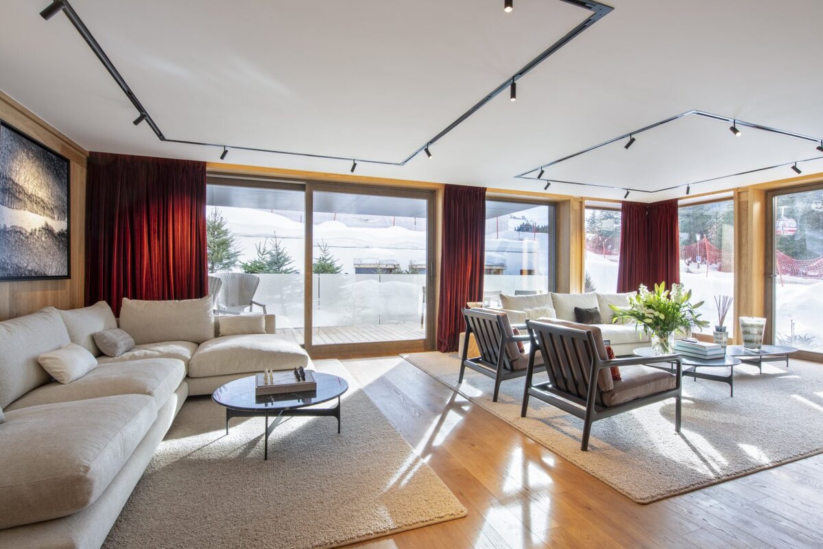 A living room with a couch and two chairs