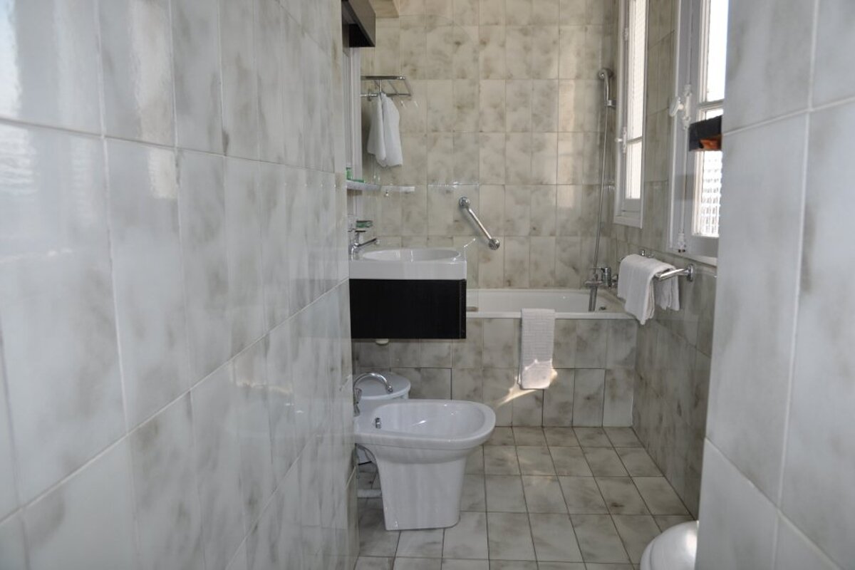 A bathroom with a sink a toilet and a bathtub