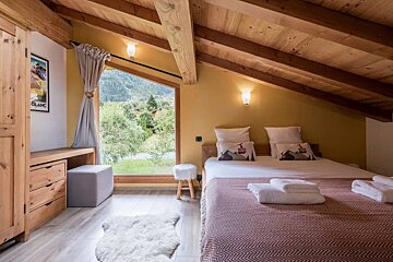 A bedroom with a bed and a picture of mont blanc on the wall