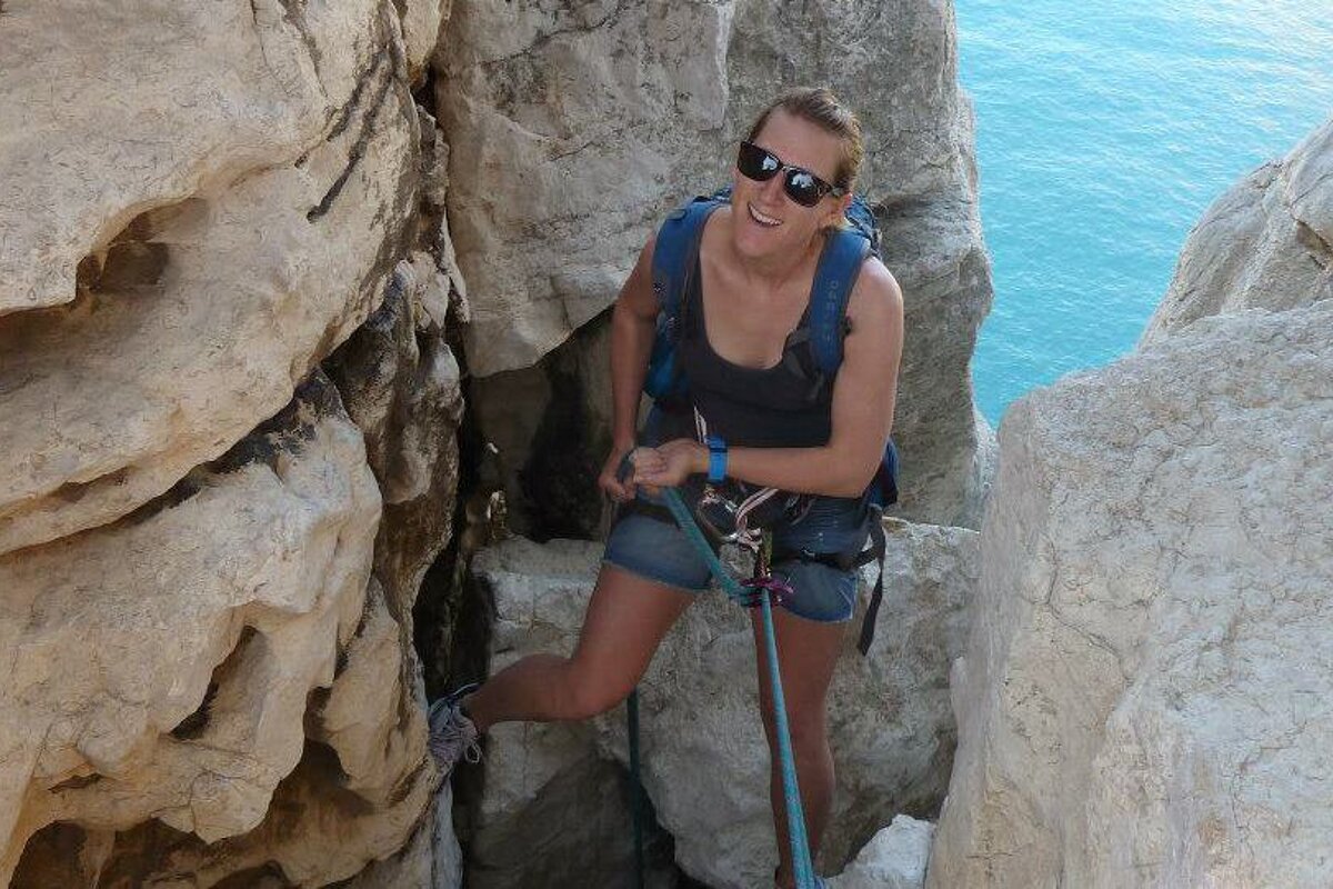 a person climbing on a sea cliff in Provence
