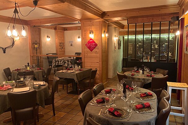 A restaurant with tables and chairs and a sign that says 