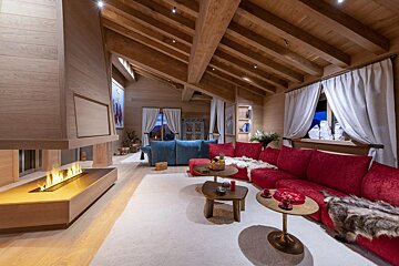 A living room with red couches and a fireplace