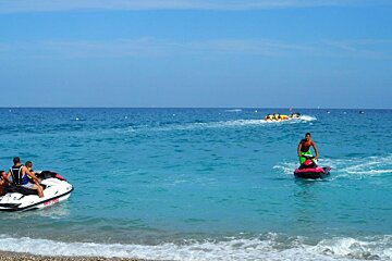 a group of people on jet skis and inflatables