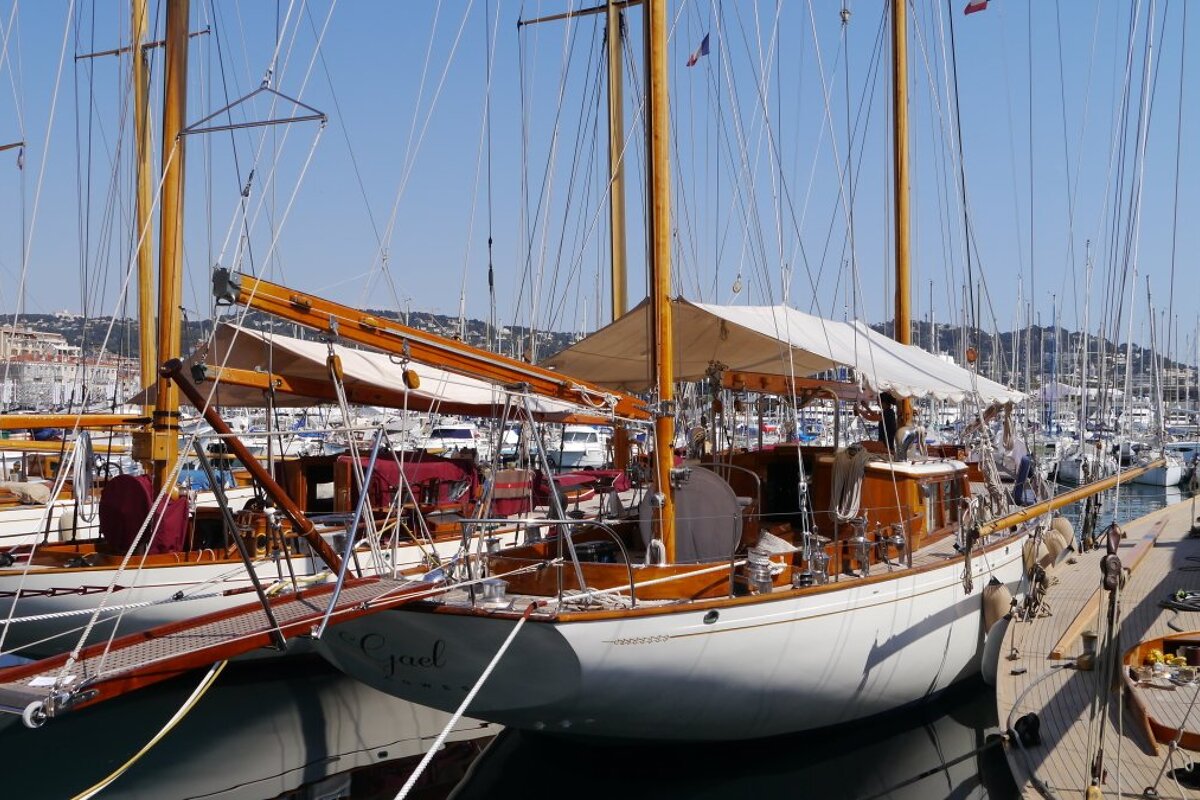 a row of traditional wooden yachts in cannes