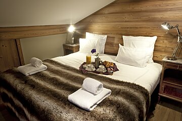 A bed with a tray of food on it