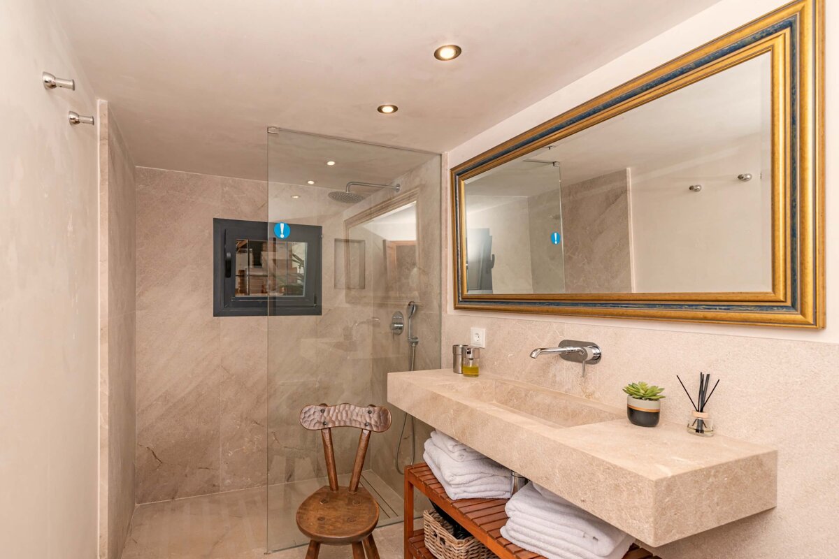 A bathroom with a large mirror and a sink