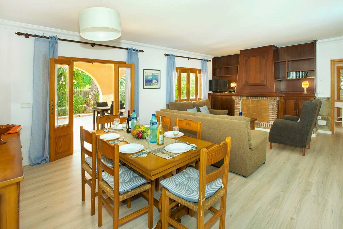 A living room with a dining table and chairs