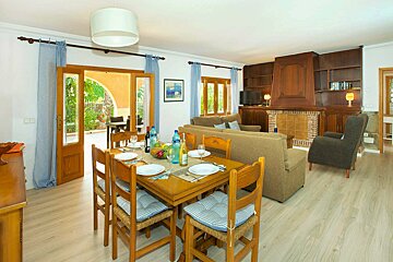 A living room with a dining table and chairs